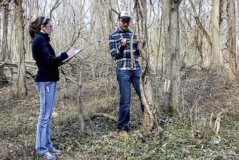Environmental science major Katie Ollier records data with fellow researcher Freeman.
