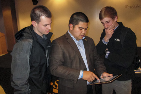 SGA President John Jose shows students how to sign the petition to #SaveOurRec. Jose held a forum Friday to discuss recent rumors of NKU's outsourcing of management for the Campus Recreation Center.