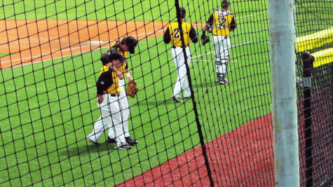 NKU team manager Ryan Mavriplis and a member of the NKU baseball team walks back to the dugout.