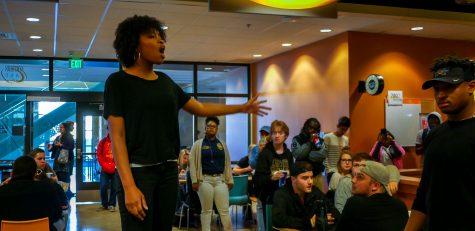 Briana Lee stood on a chair in the thick of the SU. The spoken word gets the conversation started, she said. 