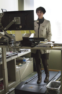 Pam Atkinson (pictured) works daily on a specially crafted treadmill desk.