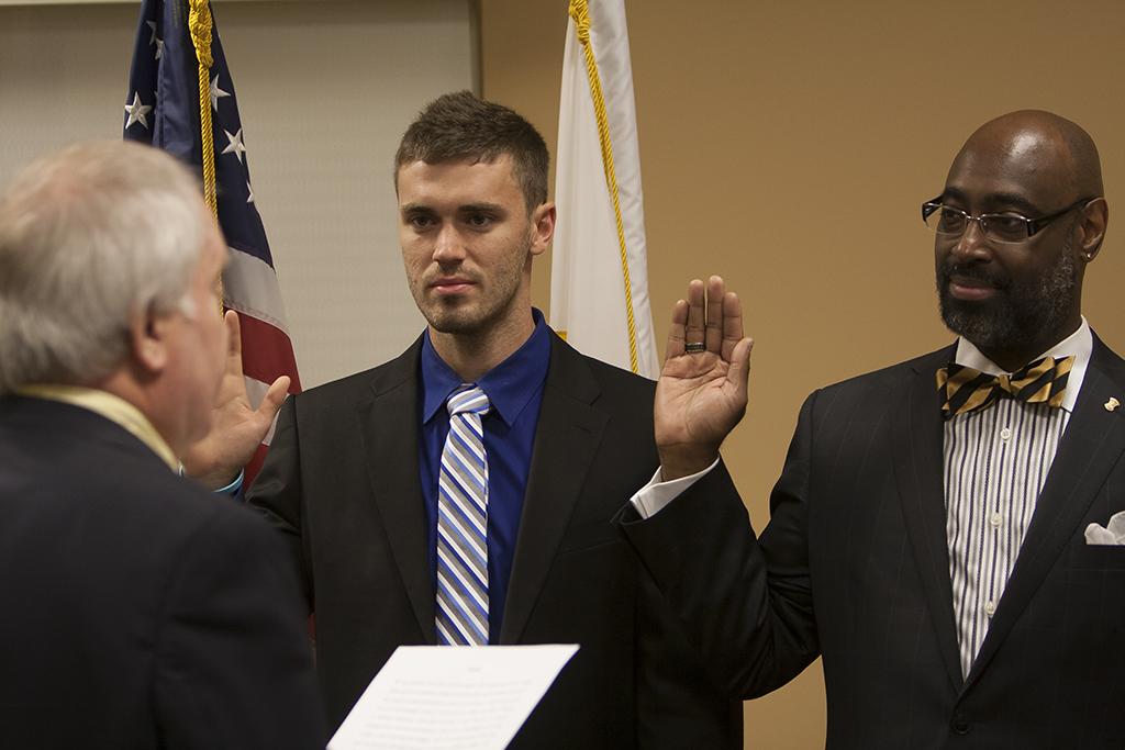 The Northern Kentucky University Board of Regents swore two Regent members in on August 16, 2013 in the Steely Library on NKU Campus. Board of Regents Chair Dennis Repenning (left) swears in Erik Pederson (center) and Andrá Ward (right) at the Board of Regents Meeting.