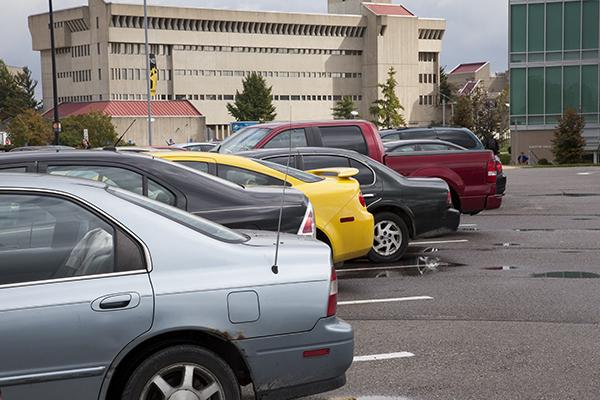 Cars in a parking lot across from Griffin Hall. Many students say that having the right car can save you money at the gas pump.