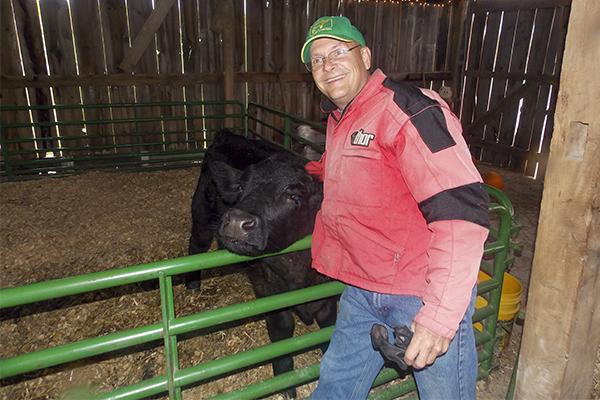 Farm Haven co-owner Stuart Ferguson embraces his calf Caeser. Farm Haven is one of several Northern Kentucky farms offering fall-themed family activities this halloween season.