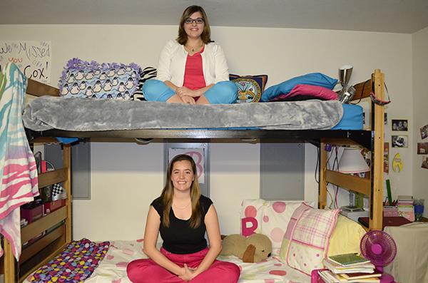 Katie Cox (top) and Brandi Cunningham (bottom) sit in their Kentucky Hall dorm room. The two friends have harnessed their differences to help each other succeed throughout college, like serving on NKU's Student Government Association.