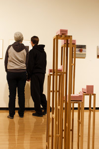 Artwork surrounds students viewing the main art gallery.