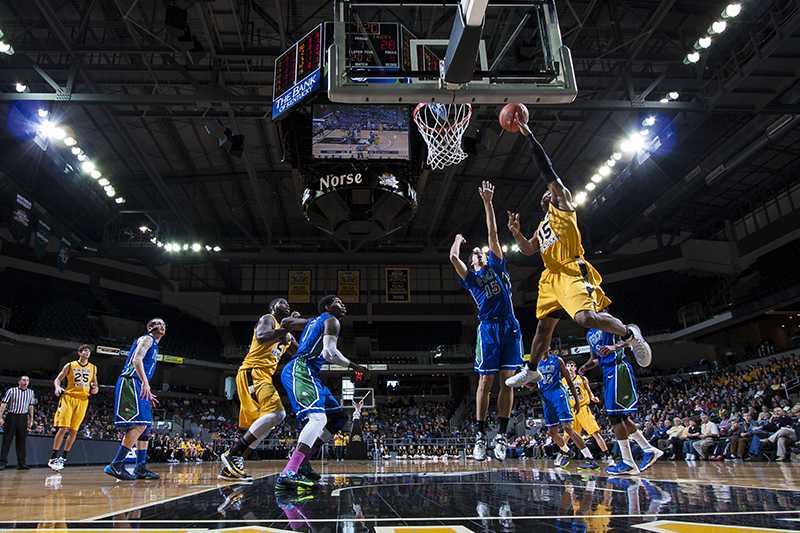 Junior guard Daniel Camps attempts a lay up against FGCU on March 1, in the Bank of Kentucky Center.