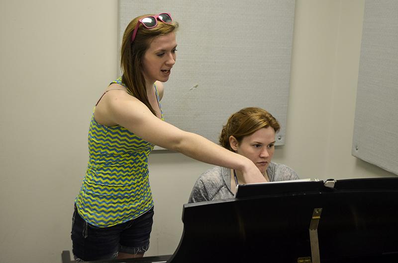 Freshmen theatre majors Kristen Schisler and Lauren Frizzell practice singing and playing piano together. 