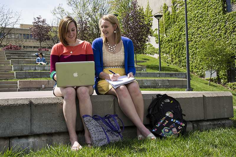 Erin Kirker (right) sits with friend Kelsey Patterson (left) in the outdoor amphitheater on campus. Kirker and Patterson have been friends since Freshman year and will graduate together on May 10.