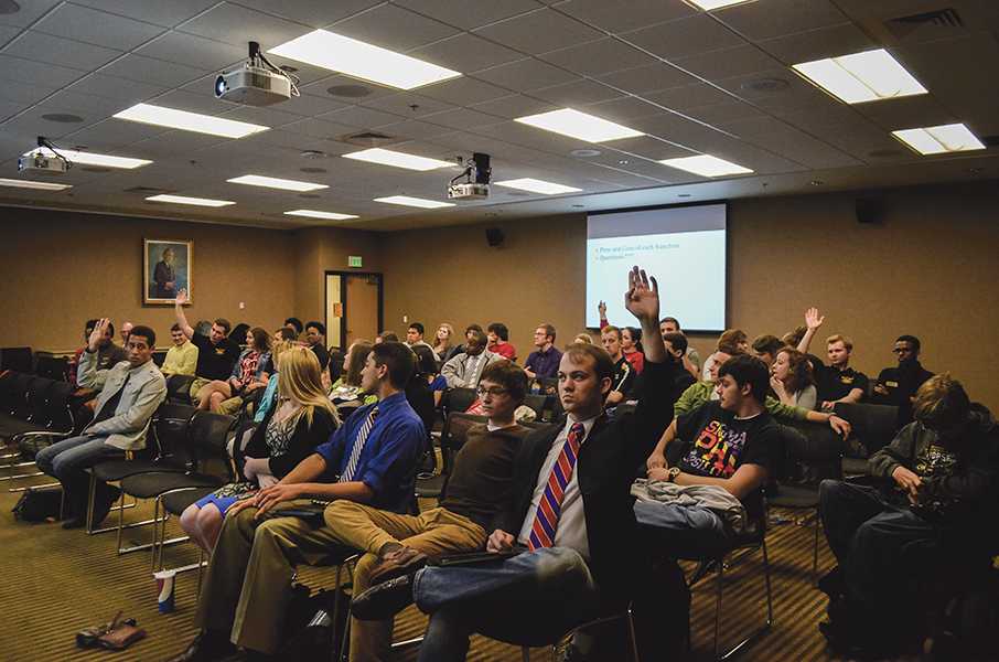 Students raise their hands to voice their opinions on what food franchise should come to campus. 