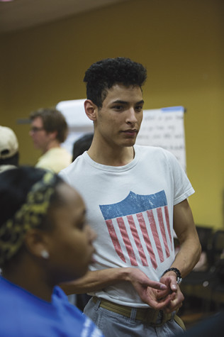 Student Marcel Hughes gives his suggestions about the university's dorms to the Student Enrollment committee member.