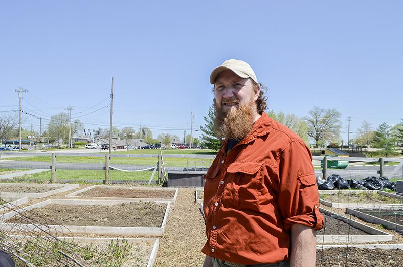 Shannon Bentz, adjunct psychology professor and community garden coordinator, stands in one of the community gardens. 