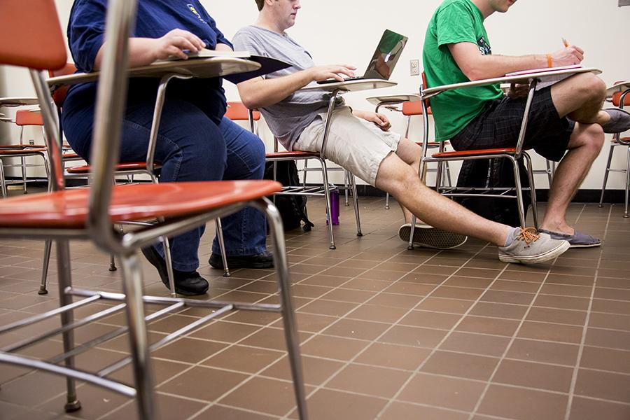 Several NKU students struggle to fit comfortably in desks in Founders Hall. Groups of students have shared their frustrating experiences with the small desks found in Landrum Academic Center and Founders Hall with The Northerner.