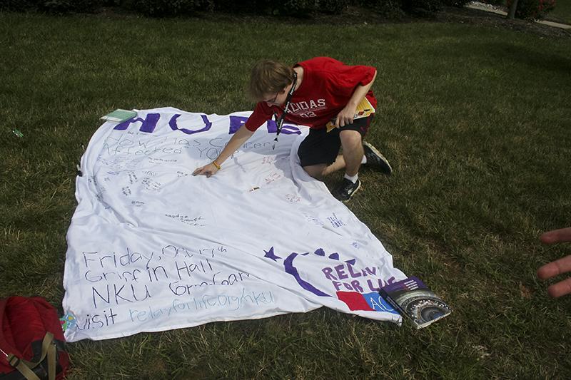 Students could write on the Relay for Life banner if someone they knew was affected by cancer or just to write words of encouragement. File photo, Aug. 26, 2014.