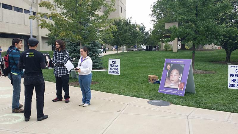 Students discuss the rights and wrongs of abortion among graphic pictures placed outside the Student Union. 