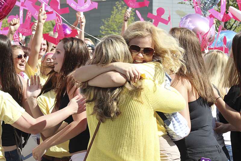 Two Delta Gamma's hug after announcing their new sisters.