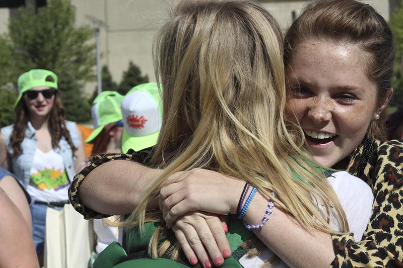 Two members of Alpha Omicron Pi hug in celebration of welcoming new sisters. 