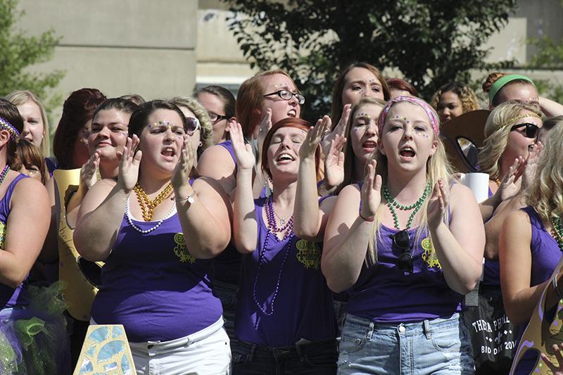 Bid day participatns chant and yell together. 