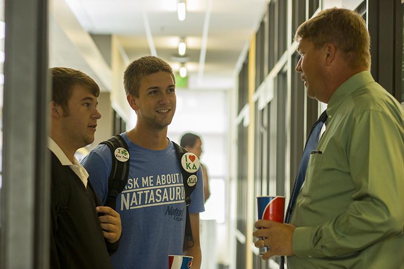 Dean Waple interacts with students Karl Bragg and Matt Kriege during his lunch break in the Student Union. 