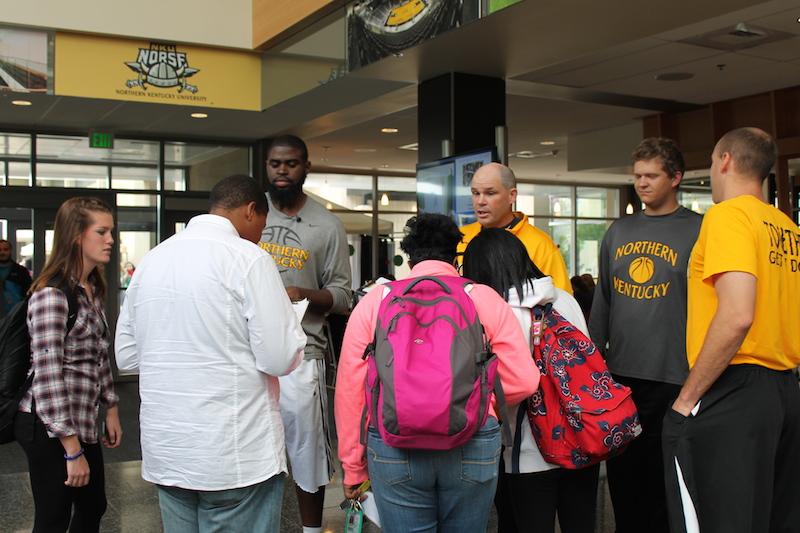 Jalen Billups and mens basketball Head Coach Dave Bezold try to persuade a group of people on who to side with.