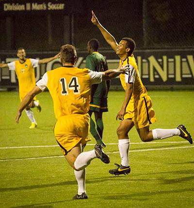 NKU player Kobie Qualah (right) celebrates after scoring his second goal of the night in NKU's come from behind overtime win on Tuesday night. The Norse beat Wright State 4-3 in overtime on September 23, 2014 at NKU Soccer Stadium.