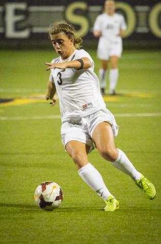 NKU forward Macy Hamblin dribbles the ball at the goal in NKU's 2-1 overtime loss Wednesday night. NKU lost in overtime 2-1 against Butler University at NKU Soccer Stadium on Wednesday, Sept. 17, 2014.