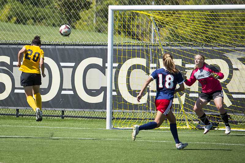 NKU midfielder Katelyn Newton heads the ball into the goal for the tying goal in NKUs overtime win against Robert Morris. NKU beat Robert Morris 2-1 in overtime at NKU Soccer Stadium on Sept. 14, 2014.