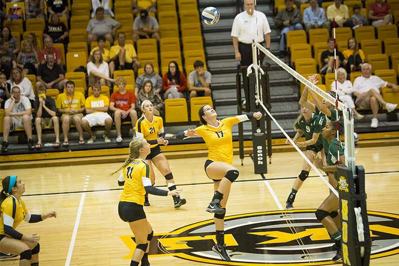 NKU middle hitter Jenna Ruble jumps to hit the ball over the net during NKUs 3-0 loss to Eastern Michigan. NKU lost to Eastern Michigan on Saturday, Sept. 6, 2014 at Regent Hall in the inaugural Northern Kentucky Volleyball Invitational and finished 2-1 in the tournament. 