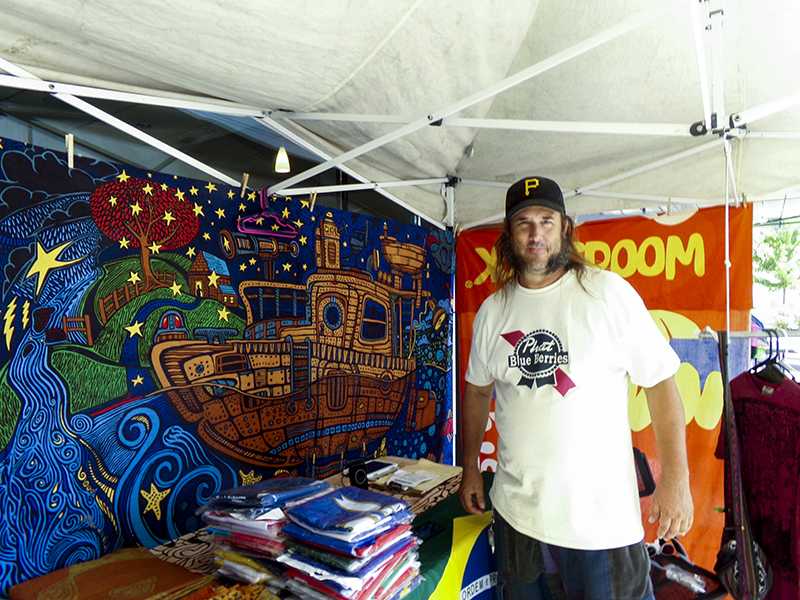 Tye Dye Thom satands with his merchandise. He raises money at his booth and donates portions of it to the Panahellenic group, which supports 26 sororities. 
