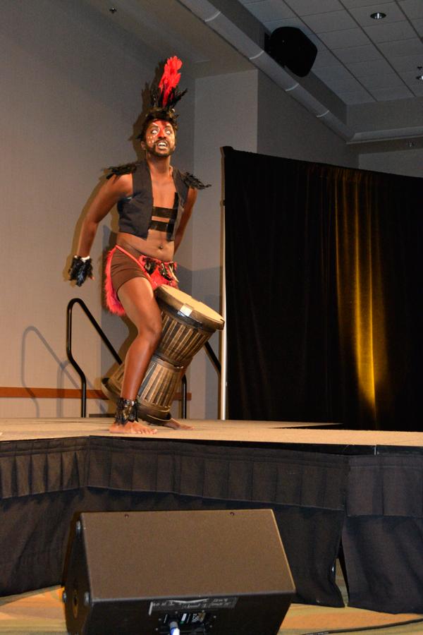 Alexander Cameron plays the conga in costume during the drag show. Audience members attempted to throw dollar bills onto the conga in between beats.