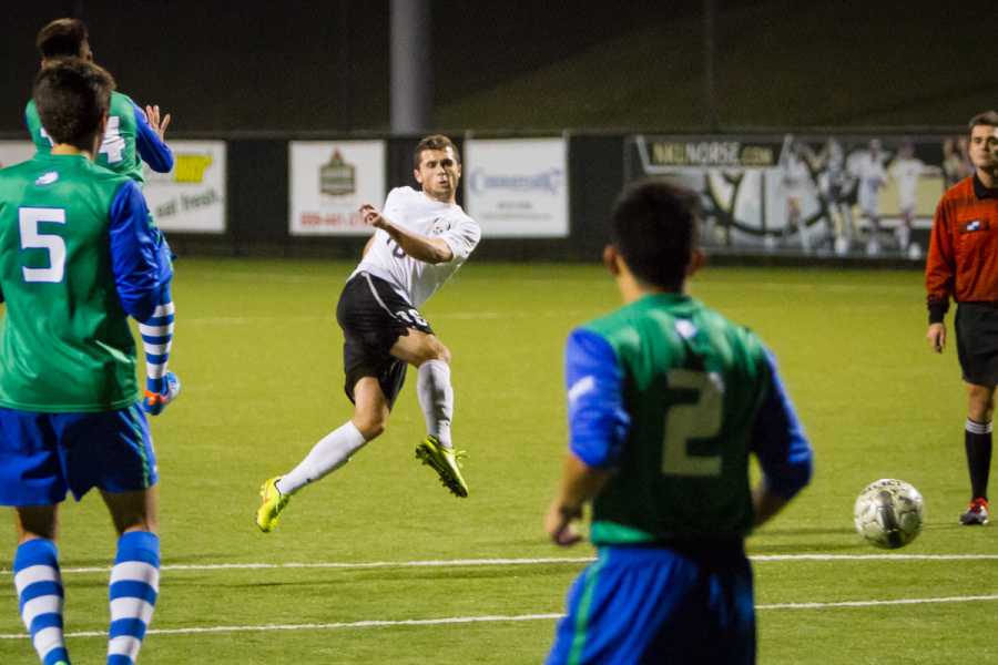 NKU's Cian McDonald shoots the ball in the second half for NKU's lone goal during NKU's 3-1 loss to FGCU. The Norse lost 3-1 to Florida Gulf Coast University at NKU Soccer Stadium on Saturday, Oct. 11, 2014.