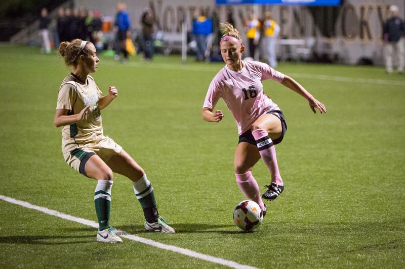 NKU player Kelsey Laumann dribbles against a defender in NKUs 1-0 loss to Jacksonville Friday night. NKU lost to Jacksonville 1-0 at NKU Soccer Stadium on Oct. 3, 2014.