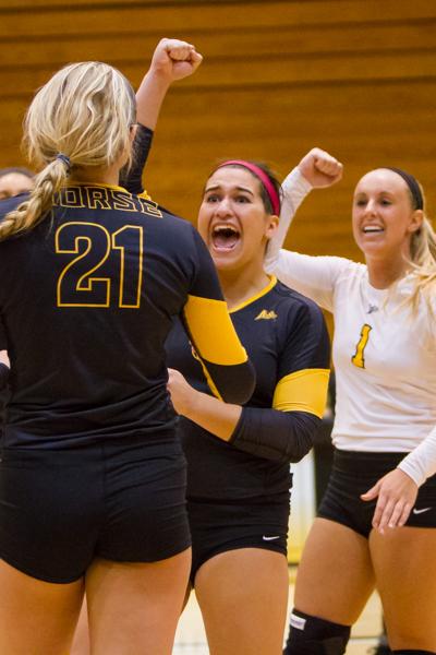 NKUs Lauren Hurley (center) celebrates after a scored point with Jayden Julian (left) and Mel Stewart (right). Lauren had 4 aces during NKUs 3-0 win against Jacksonville at Regents Hall on October 11, 2014.