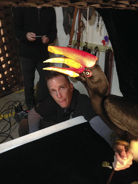 A trainer helps a bird pose for a photo at the Cincinnati Zoo. Evan Sgouris took this photo as a means of documenting his experience with Sartore.