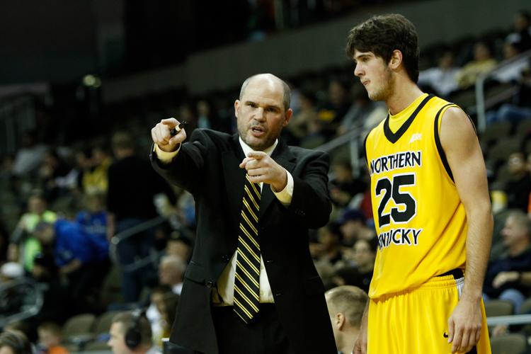 Coach Dave Bezold talks to Cole Murray during a game in the 2013-14 season. 