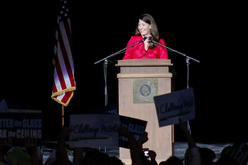 Alison Lundergan Grimes smiles at the standing ovation she is receiving. Grimes made a campaign stop at The Bank of Kentucky Center Saturday in a last push for votes in the upcoming election.