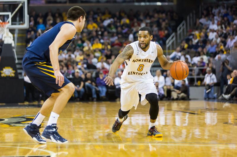 NKU men's basketball player Chad Jackson dribbles towards the hoop during the first half of NKU's 42-67 loss to West Virginia University. NKU was defeated by West Virginia University 42-67 at The Bank of Kentucky Center on Sunday, Dec. 7, 2014.