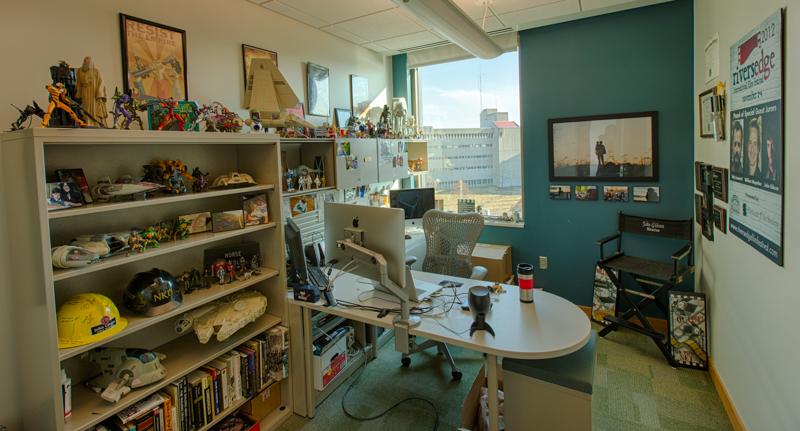 John Gibsons office is adorned with many figures, posters and a sentimental photo of him and his father.