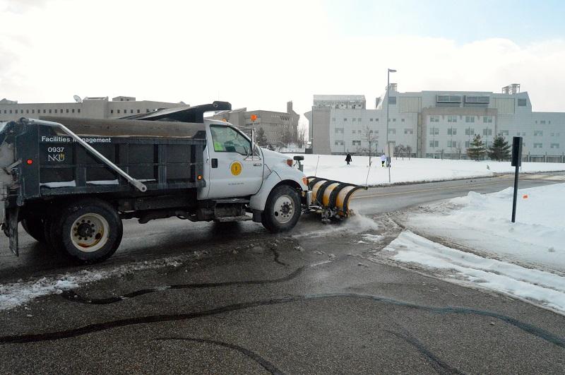 A+snow+plow+pushes+through+the+sludge+in+an+effort+to+clean+up+campus.+NKU+was+closed+Wednesday%2C+Feb.+18+due+to+inclement+weather.+