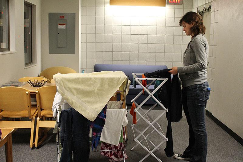 Freshman Elizabeth Gieske hangs wet towels in a hallway of Kentucky Hall to dry. The media informatics major said excessive moisture in her room prevented towels and clothes from drying.