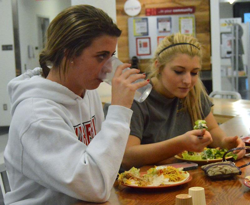 Freshmen Macy Hamblin and Morgan Shafer enjoy a meal at The Village Café in Norse Commons. Vegetarian, gluten-free, and Healthy U options are offered every day. 

