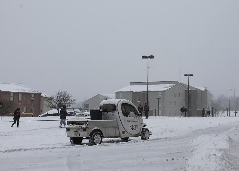 Students battle the snow to move through the residential village. Due to the numerous cancellations in recent weeks, campus workers have clocked less hours.