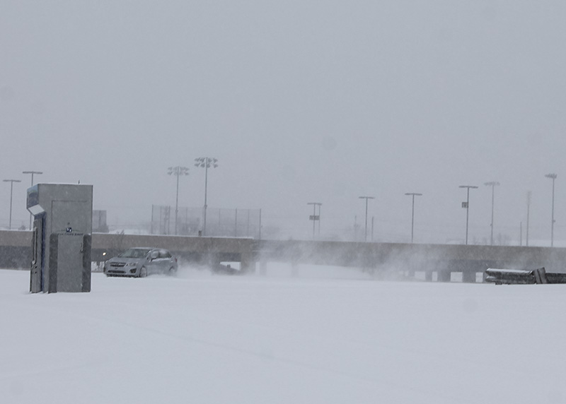 A car does tricks in the snow in a vacant lot on campus. NKU was closed Monday, Feb. 16 due to inclement weather.