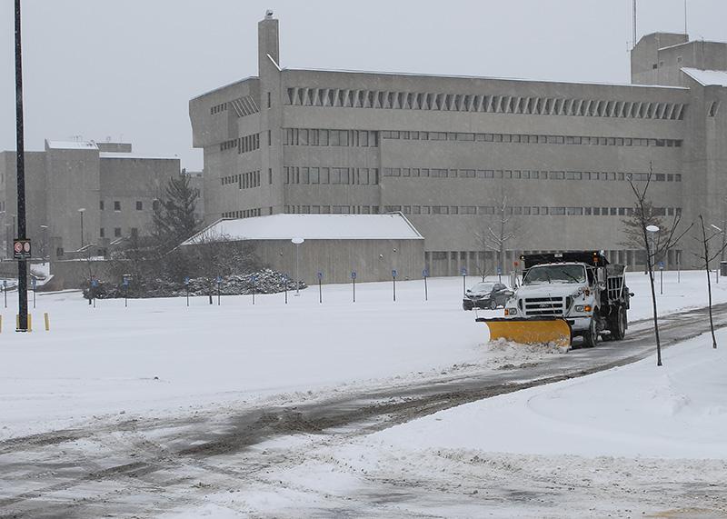 Snow plow trucks work to clear roadways on campus. NKU was closed Monday, Feb. 16 due to inclement weather.