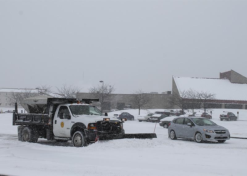 Snow plow trucks work to clear parking lots on camous. NKU was closed Monday, Feb. 16 due to inclement weather.