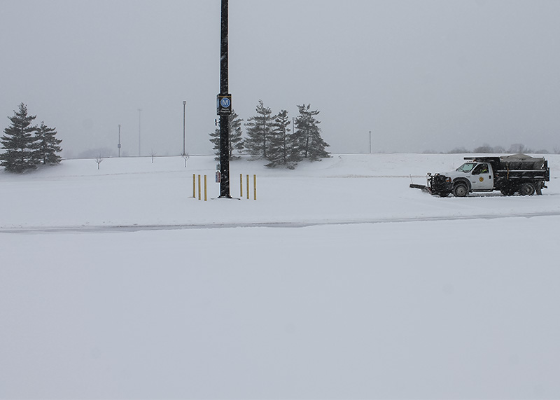 Snow plow trucks work to clear parking lots on campus. NKU was closed Monday, Feb. 16 due to inclement weather.