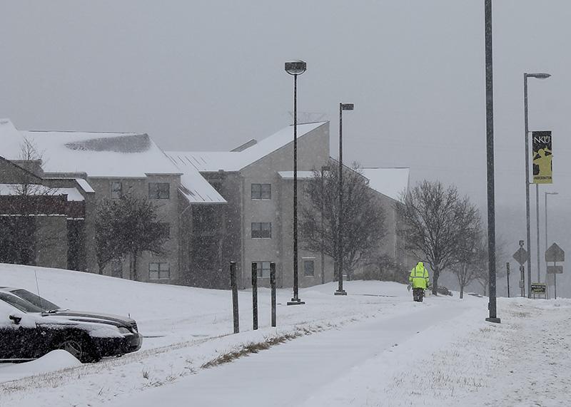 A maintenance member works to clear the snow as it continues to fall. NKU was closed Monday, Feb. 16 due to inclement weather.