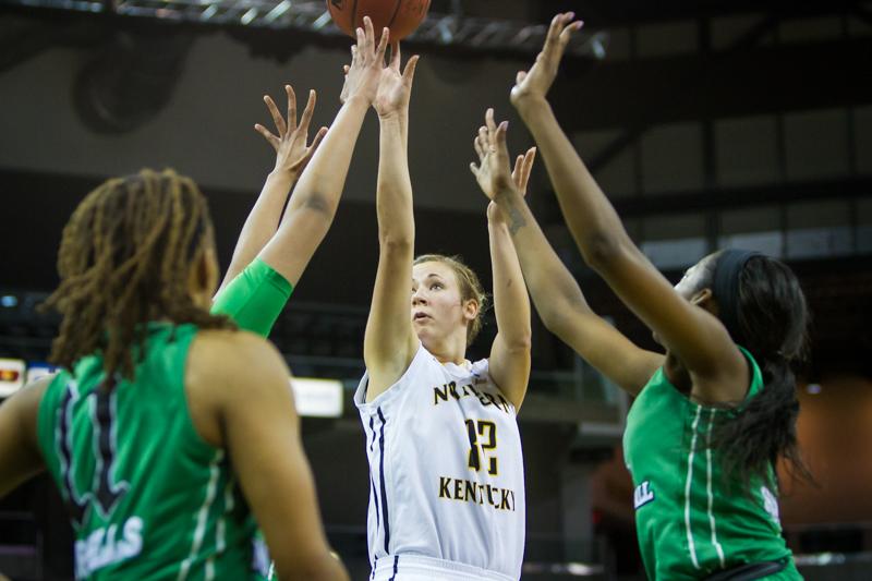 NKU forward Kaitlyn Gerrety shoots the ball while being defended by two Marshall defenders. NKU lost to Marshall 81-79 in the first round of the WBI at The Bank of Kentucky Center on Thursday, Mar. 19, 2015.