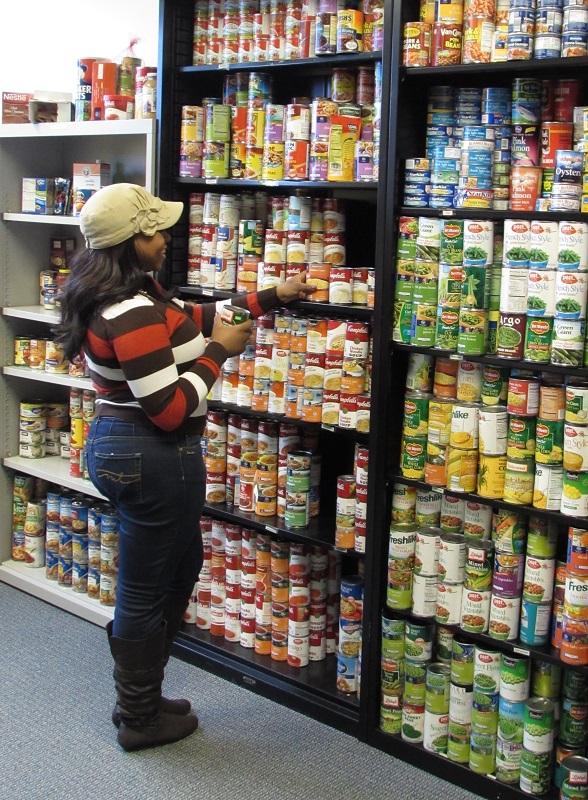 FUEL volunteer and senior social work major Kezia Slaughter stocks shelves at the FUEL NKU food pantry in Founders Hall. 