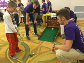 Evan Wall guides a first- time putt-putter. 